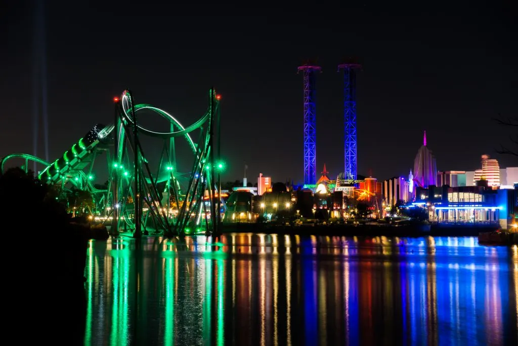 shot of islands of adventure universal at night from across the water, one of the best places to visit in the south east usa