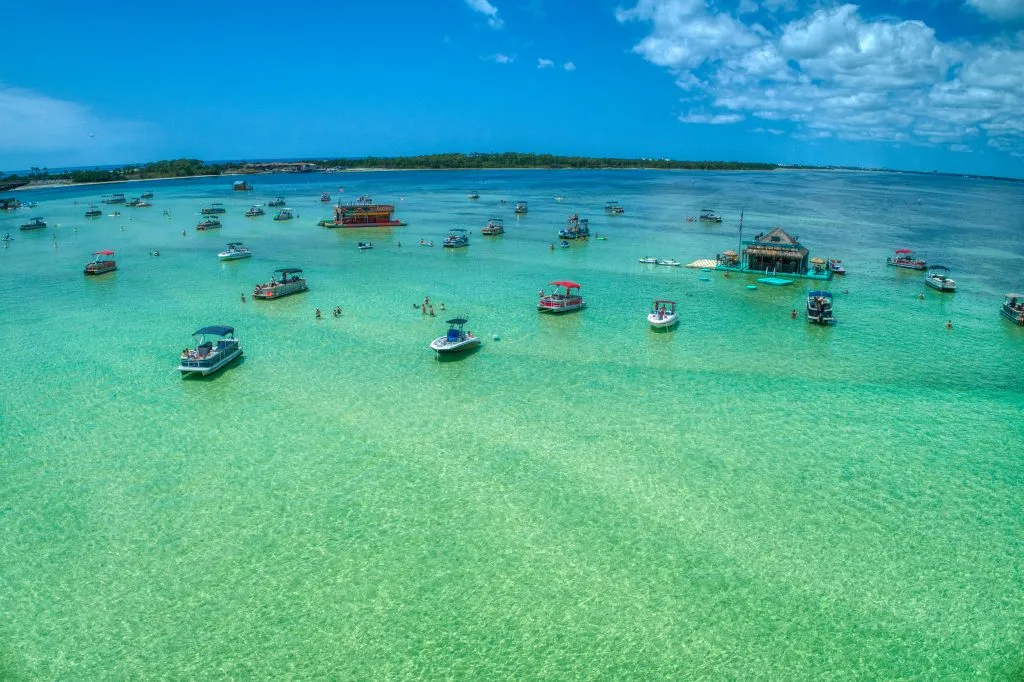 group of boats parked at crab island destin florida