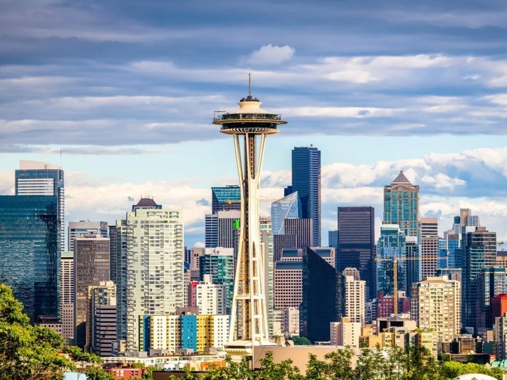 Seattle WA skyline on a cloudy day with Space Needle visible in the center--one of your first stops during this 3 days in Seattle itinerary!