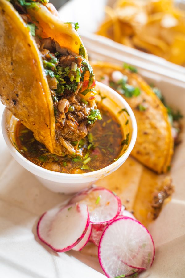 birria tacos being dipped into salsa in san francisco ca