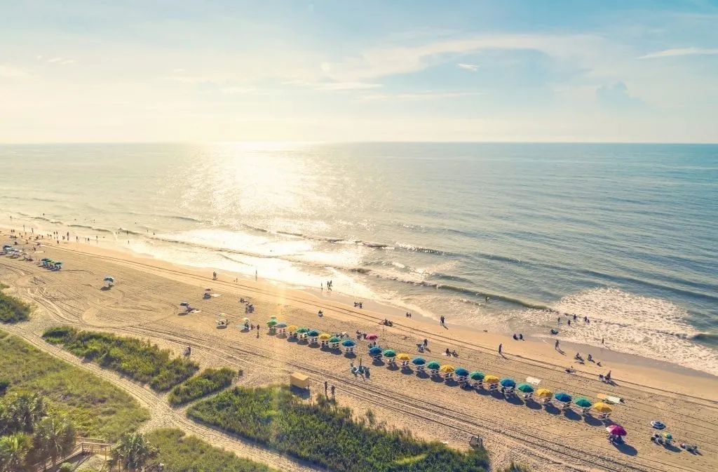 Myrtle Beach South Carolina as seen from above at sunset, with colorful umbrellas lining the beach