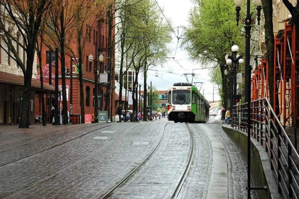 Street scene in Portland OR with a tram visible in the back right of the photo--Portland's public transport is one of the best ways to get around during 3 days in Portland!