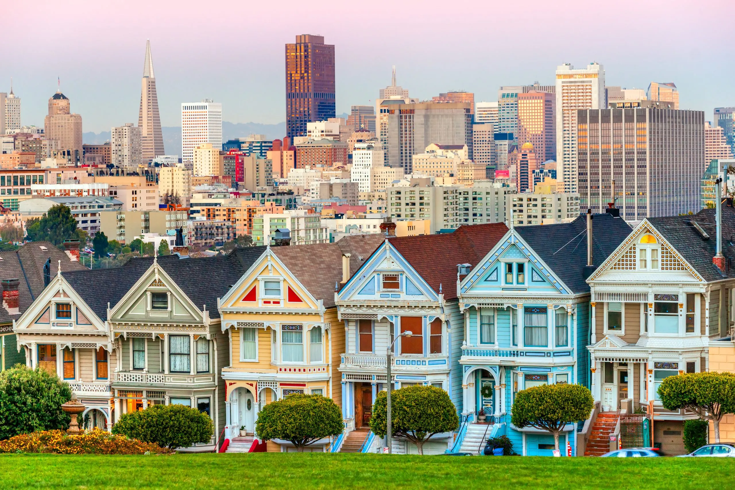 Painted ladies of San Francisco at sunset with skyline in the background, one of the best places to visit when spending 3 days in San Francisco CA