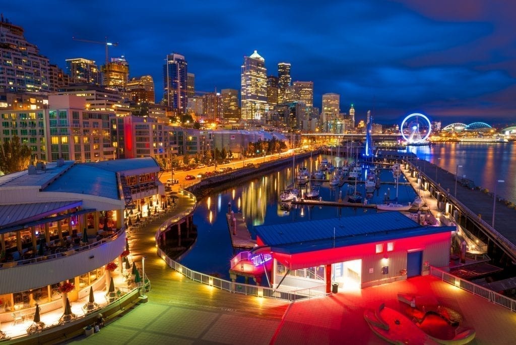 Seattle waterfront as seen at night with lights reflecting from the water