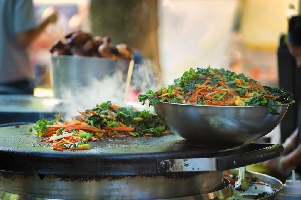 Vegetables cooking at a street food cart--a common sight on a Portland weekend getaway!