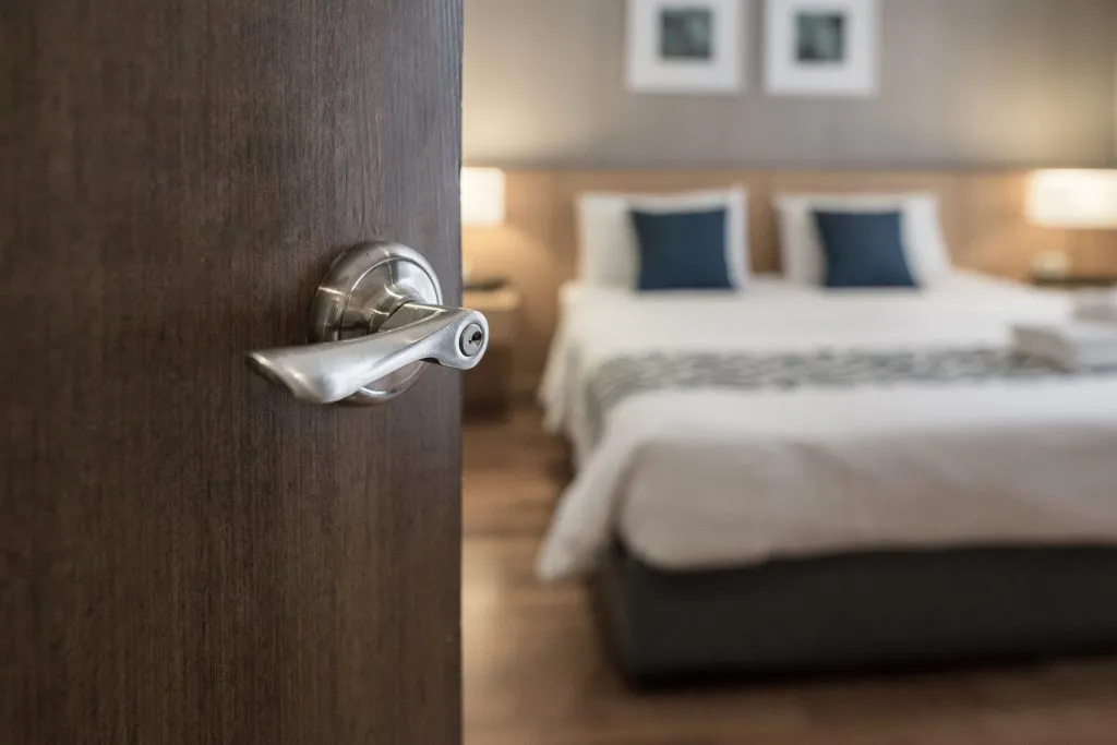 wood door opening into a hotel room