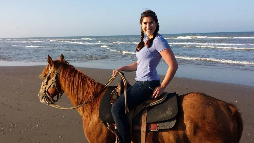 Kate Storm riding a horse on the beach on South Padre Island Texas