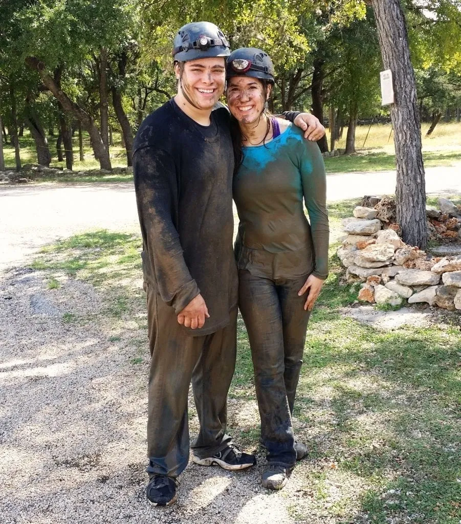 Kate Storm and Jeremy Storm covered in mud after touring Cascade Caverns on a day trip from San Antonio TX