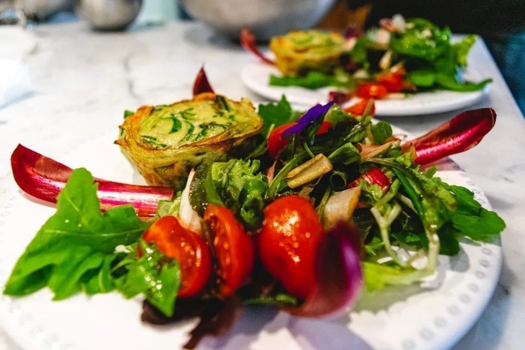 plate of greens and a tart served at a cooking class in lucca italy