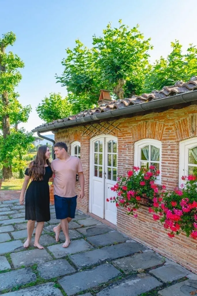 kate storm and jeremy storm in front of small building at a villa in lucca italy
