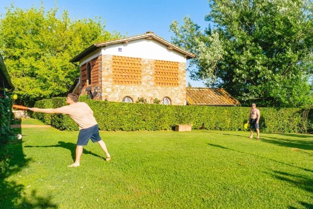 family playing frisbee at a tuscan farmhouse rental