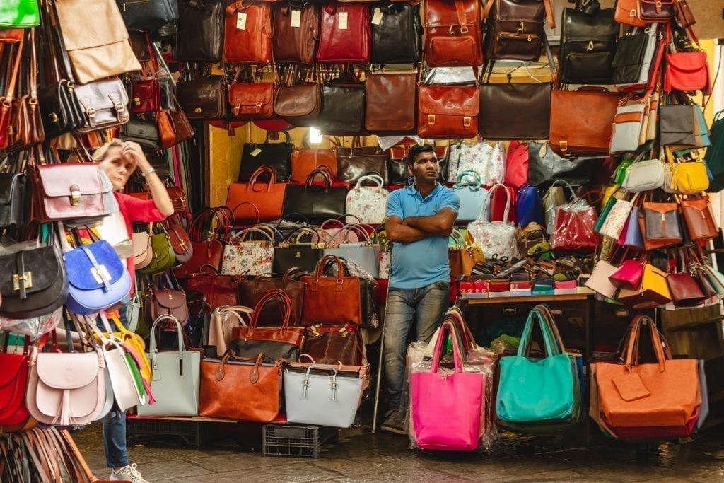leather bags for sale as souvenirs from florence italy displayed at a stall in the mercato san lorenzo