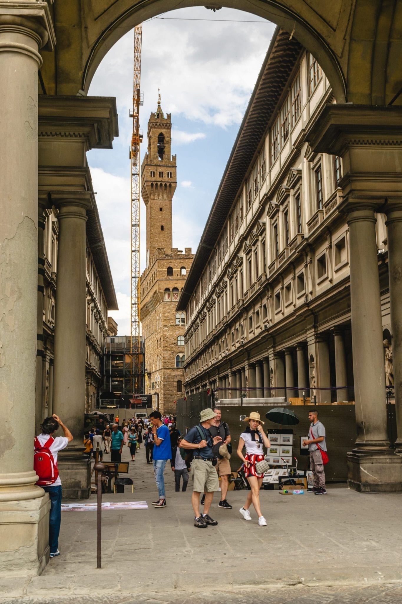 view of an archway in florence leading to piazza della signoria with palazzo vecchio visible in the background