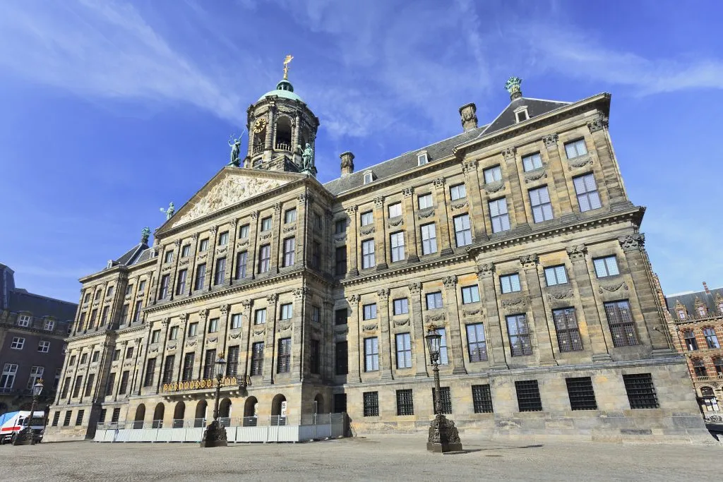 royal palace in dam square on a sunny day, a must see during a day in amsterdam the netherlands