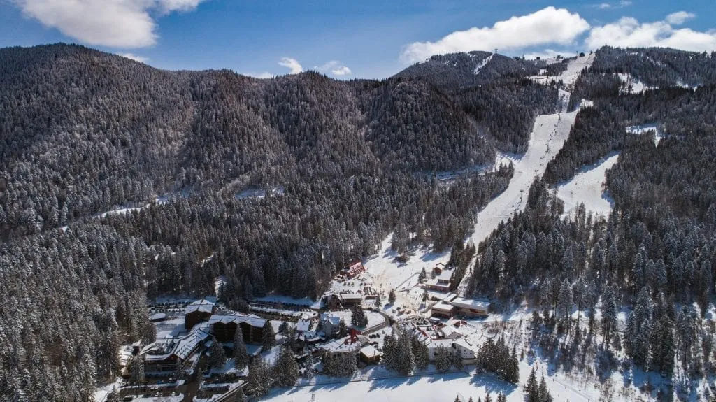 Whitefish Montana covered in snow with a ski slope visible in the background. Whitefish is one of the best christmas vacations in usa