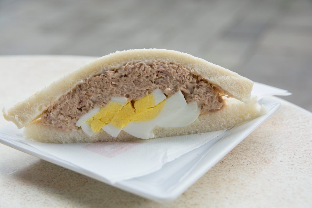 rome tramezzino with tuna and egg on a white plate