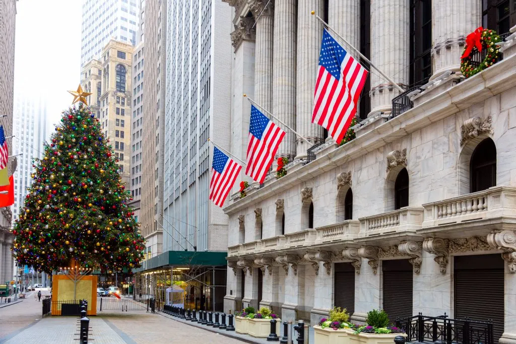 christmas tree in front of stock exchange in nyc, one of the best places to visit in usa in december