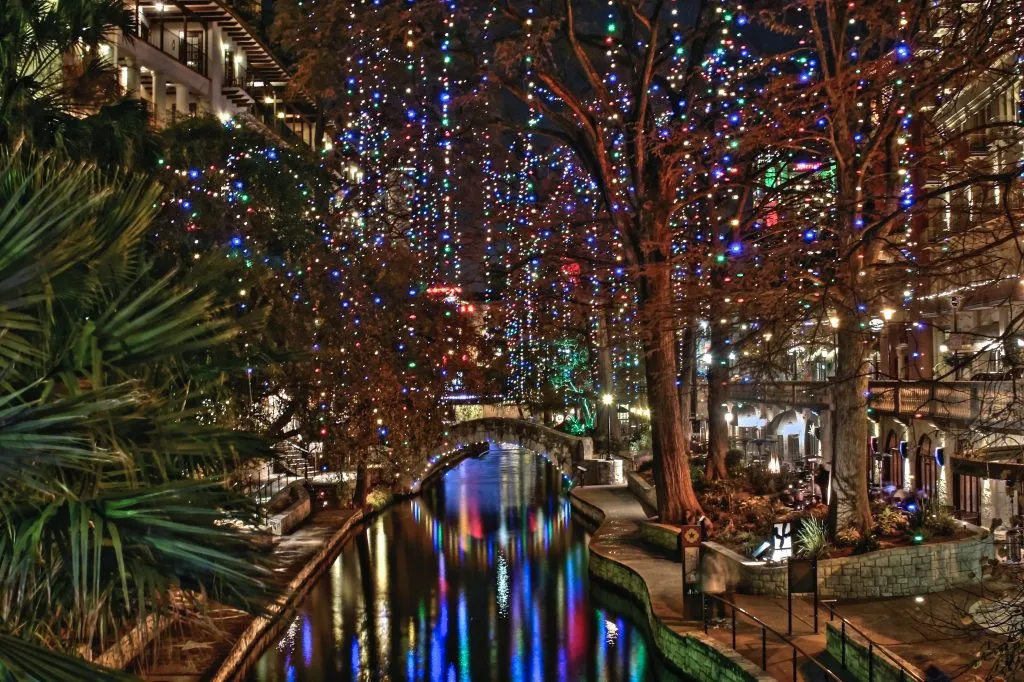 san antonio riverwalk decorated with christmas lights at night, one of the best places for christmas vacations in usa