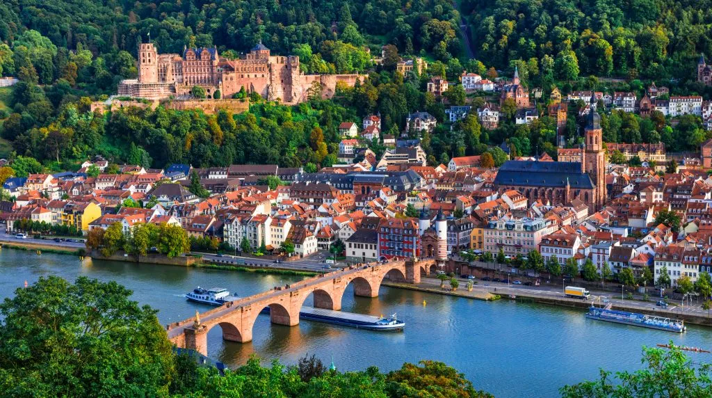 view of heidelberg germany from above with castle across the river, one of the most beautiful cities in europe to visit