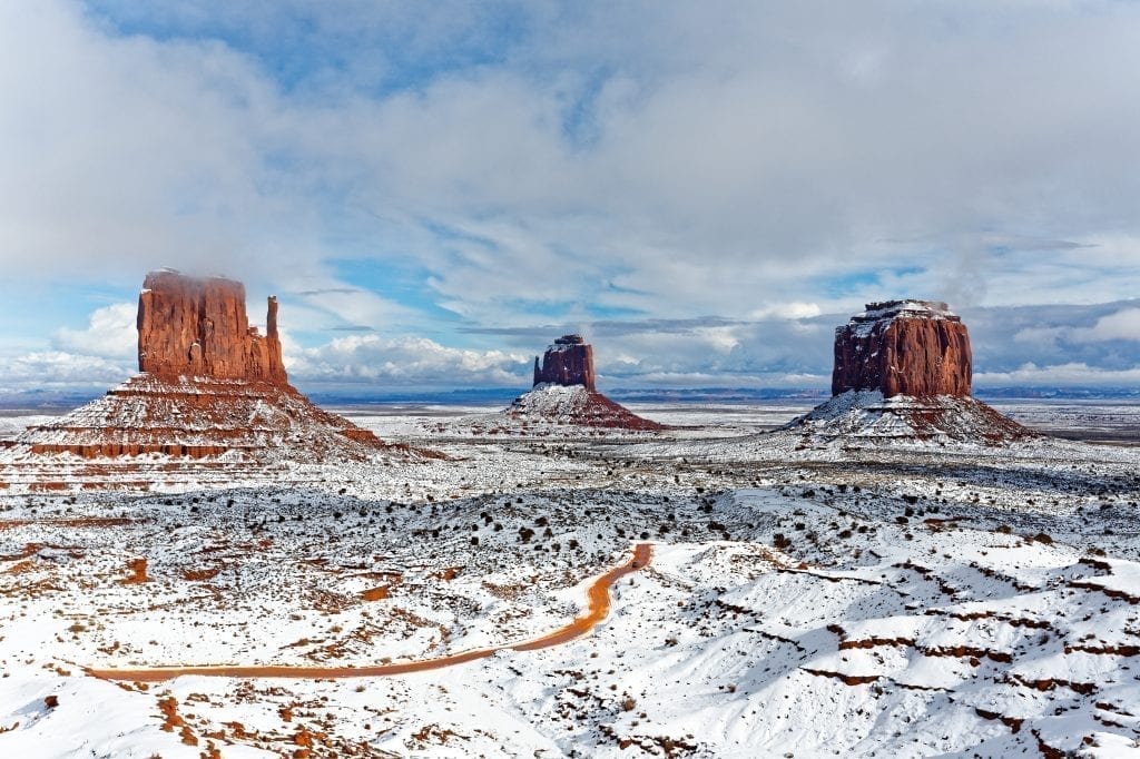 Monument Valley in winter with snow covered the ground and parts of the monuments