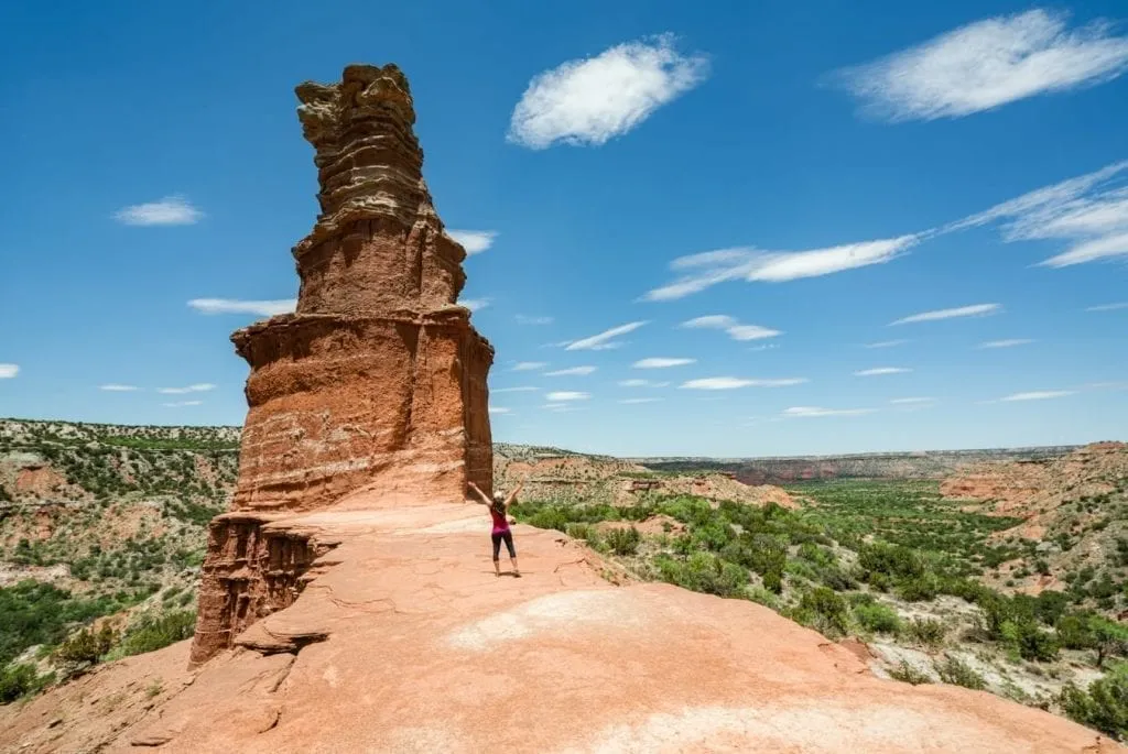 Kate Storm standing with her back to the camera in front of the Lighthouse in Palo Duro Canyon Texas