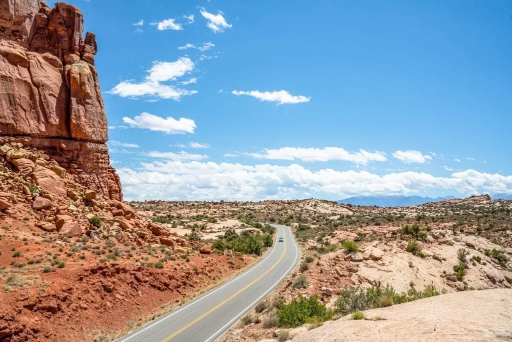 Park Loop Road in Arches Naitonal Park with a large sandstone wall on the left