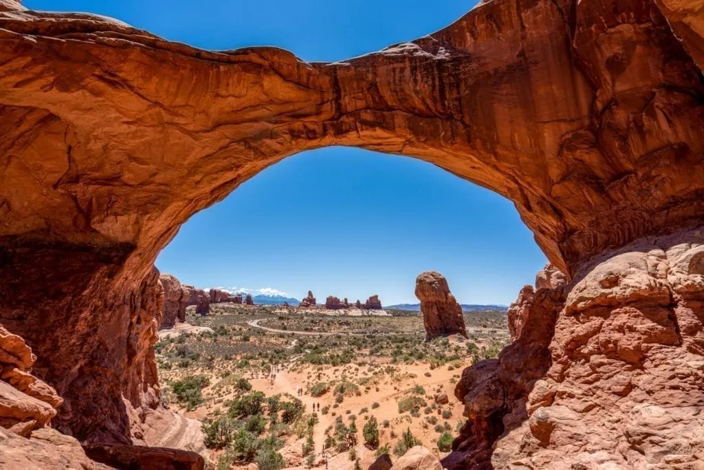 Large arch in Arches National Park with desert visible through it