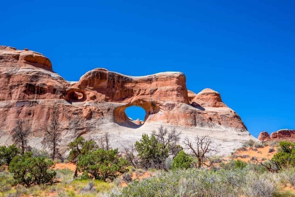 Tunnel Arch in Arches National Park as seen from across a field