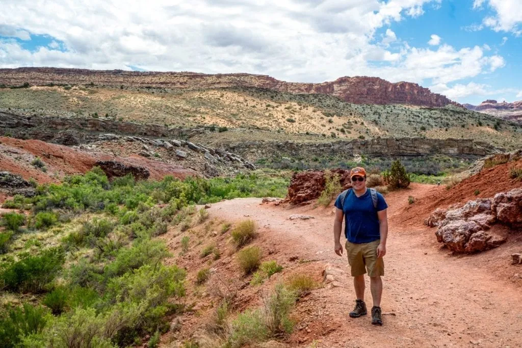 Jeremy Storm in a blue shirt on hiking to Delicate Arch in Arches NP
