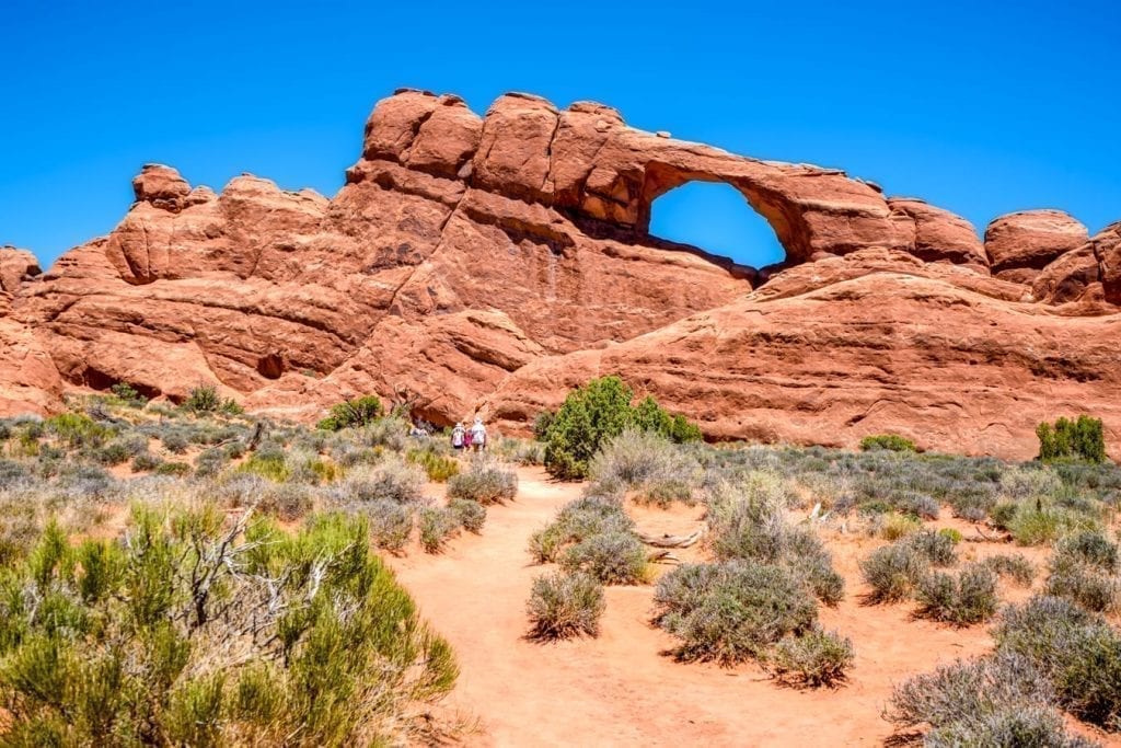 skyline arch on a sunny day seen across the desert during one day arches national park