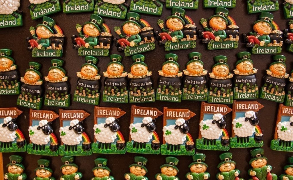 Collection of magnets in Ireland--a row of matching leprechaun magnets on top of a row of matching sheep magnets