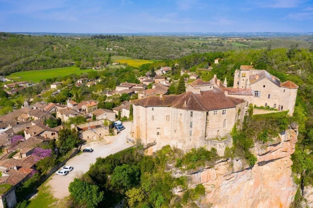 Bruniquel France as seen from above with its castle prominently features in the bottom right of the photo