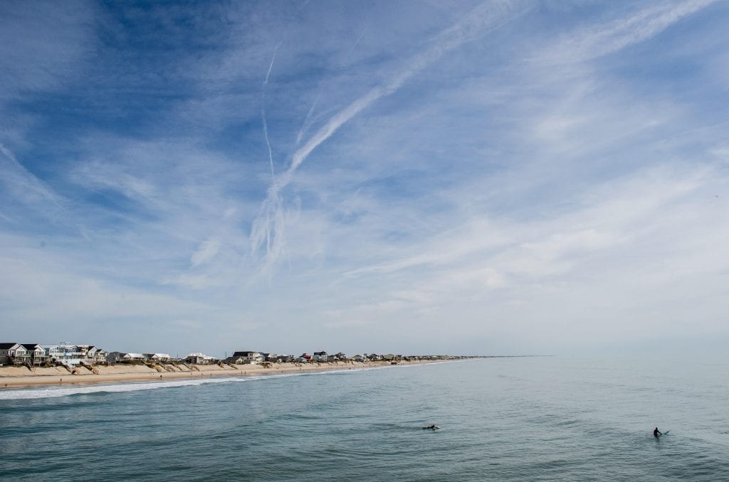 Beach on Topsail Island North Carolina, with the partly cloudy sky taking up most of the image