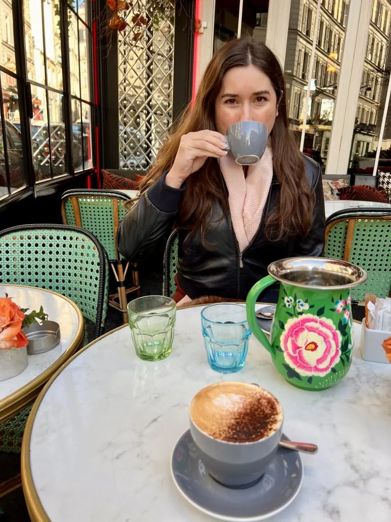 kate storm drinking coffee at a cafe in paris france breakfast