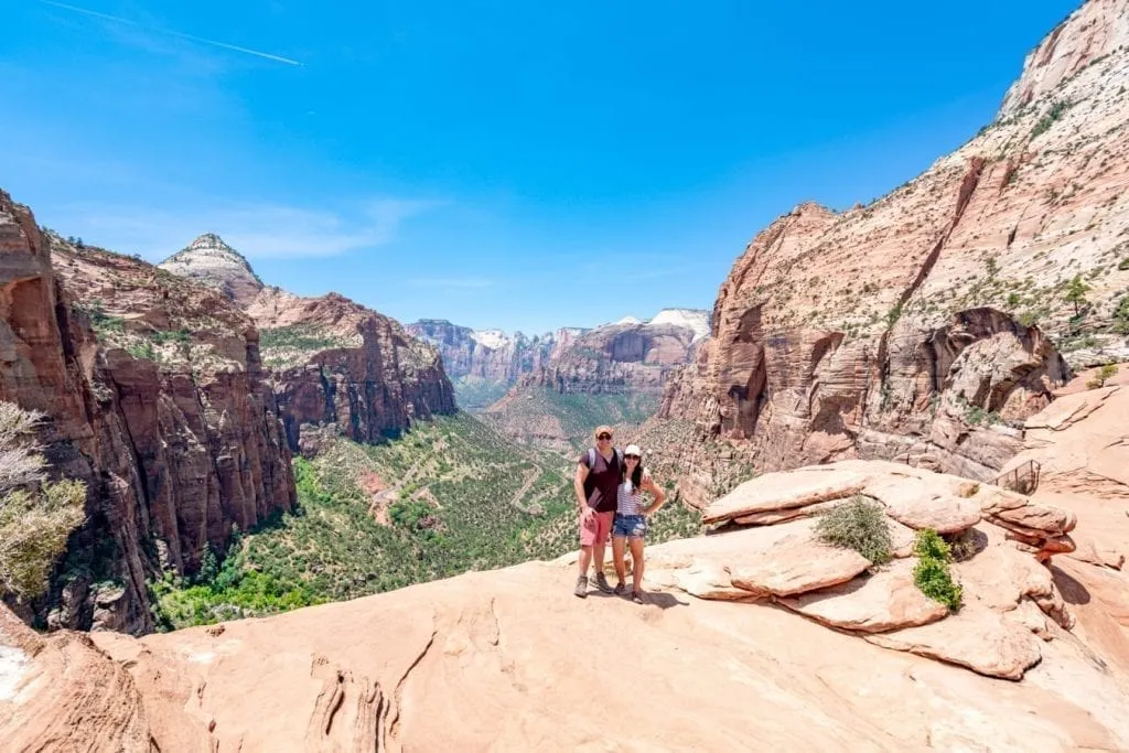 Kate Storm and Jeremy Storm standing at the summit of the Canyon Overlook Trail Zion NP