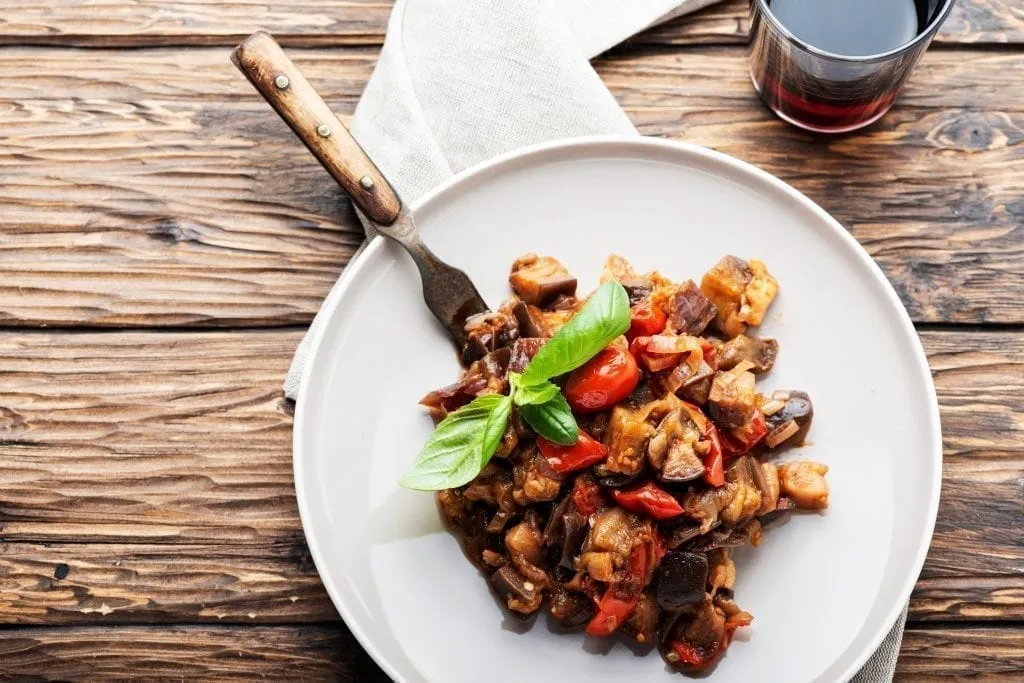 White plate of caponata, a traditional side dish in Sicily food