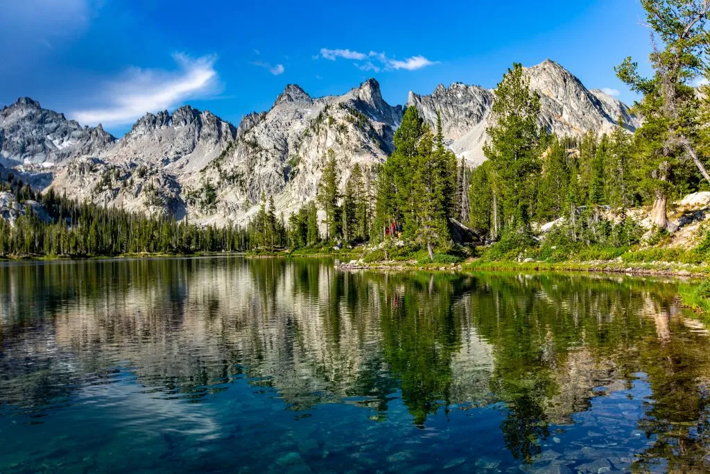 sawtooth mountains idaho on sunny day with lake in the foreground, one of the best places to vacation usa