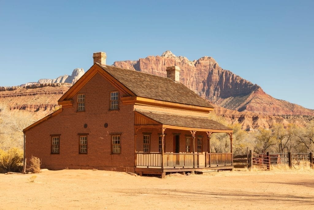 Wood building in Grafton Utah in front of a rock formation near Zion National Park