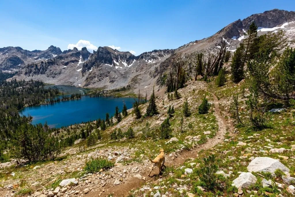 Sawtooth Mountains Idaho with a lake visible on the left of the photo and mountain peaks in the background. These mountains definitely belong on your USA bucket list!