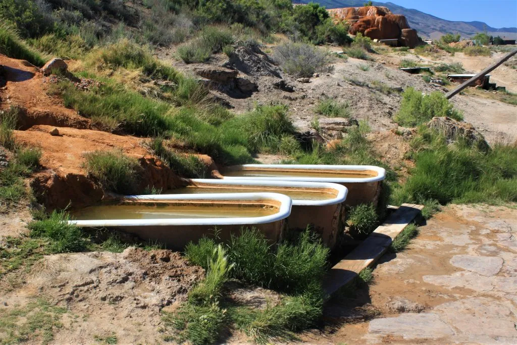 tubs of natural hot spring water at mystic hot springs, a popular utah vacation destination