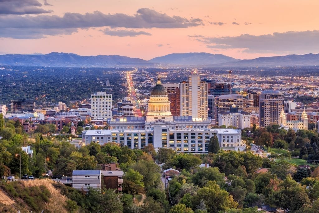 Skyline of Salt Lake City at sunset with the Utah Capitol Building in the center. Salt Lake City is one of the best cities to visit in Utah