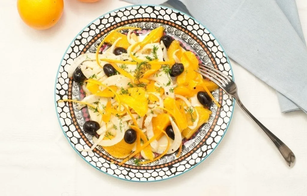 Insalata siciliana shot from above and topped with onions and black olives