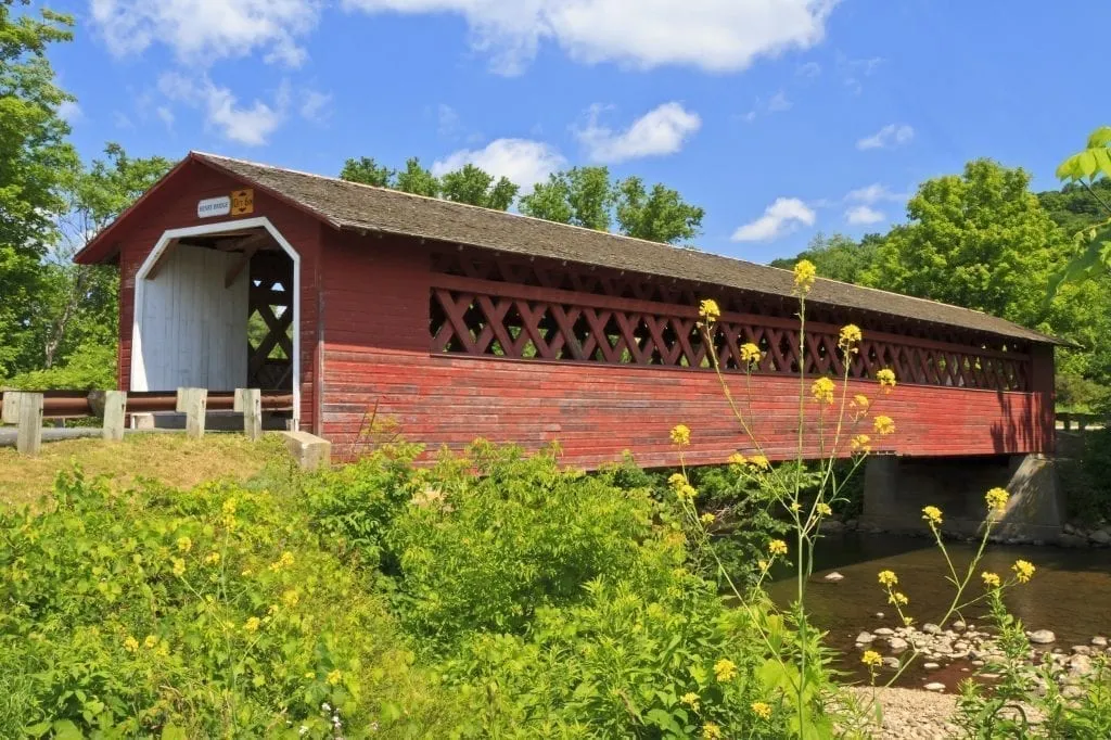 Historic Henry Covered bridge in Bennington Vermont painted with aging red paint