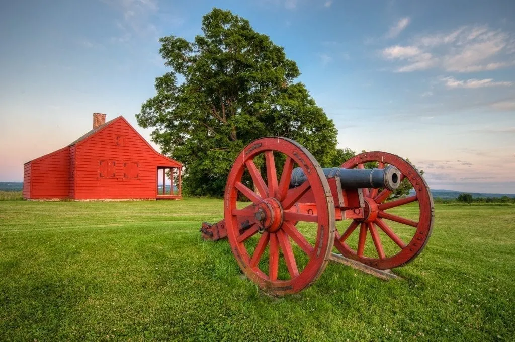 Historic red farmhouse and cannon near Saratoga NY, one of the best weekend trips from boston MA