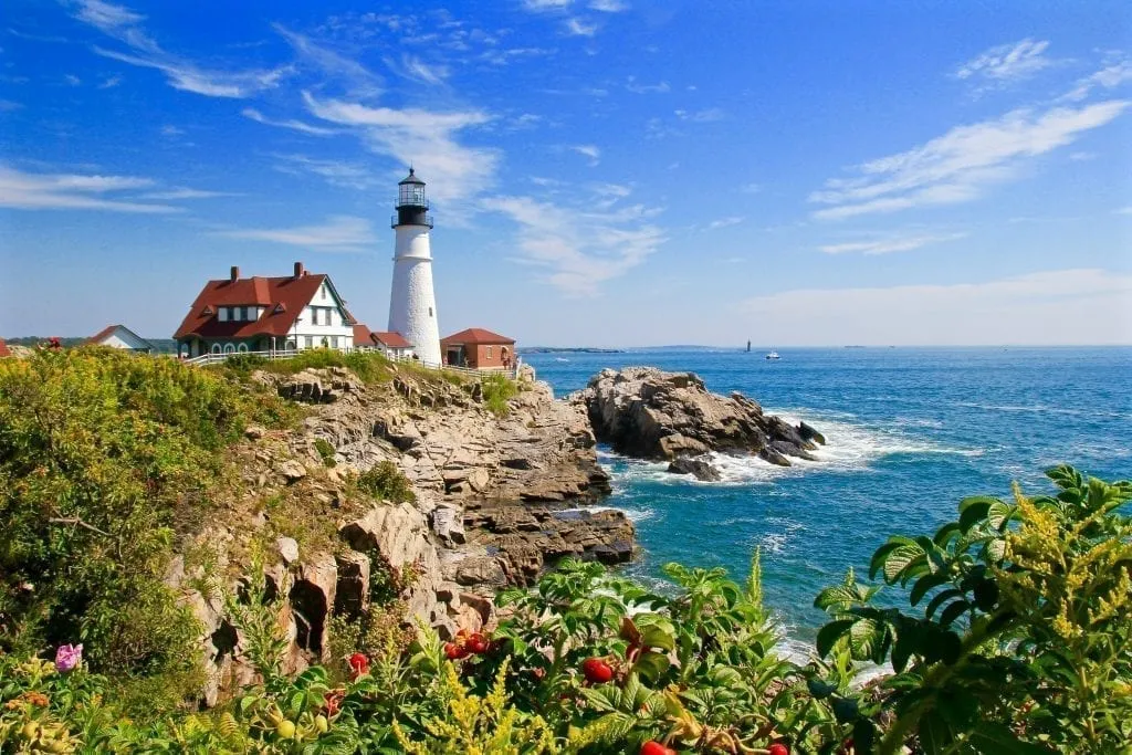 Portland Head Light on a sunny summer day with flowers in the foreground
