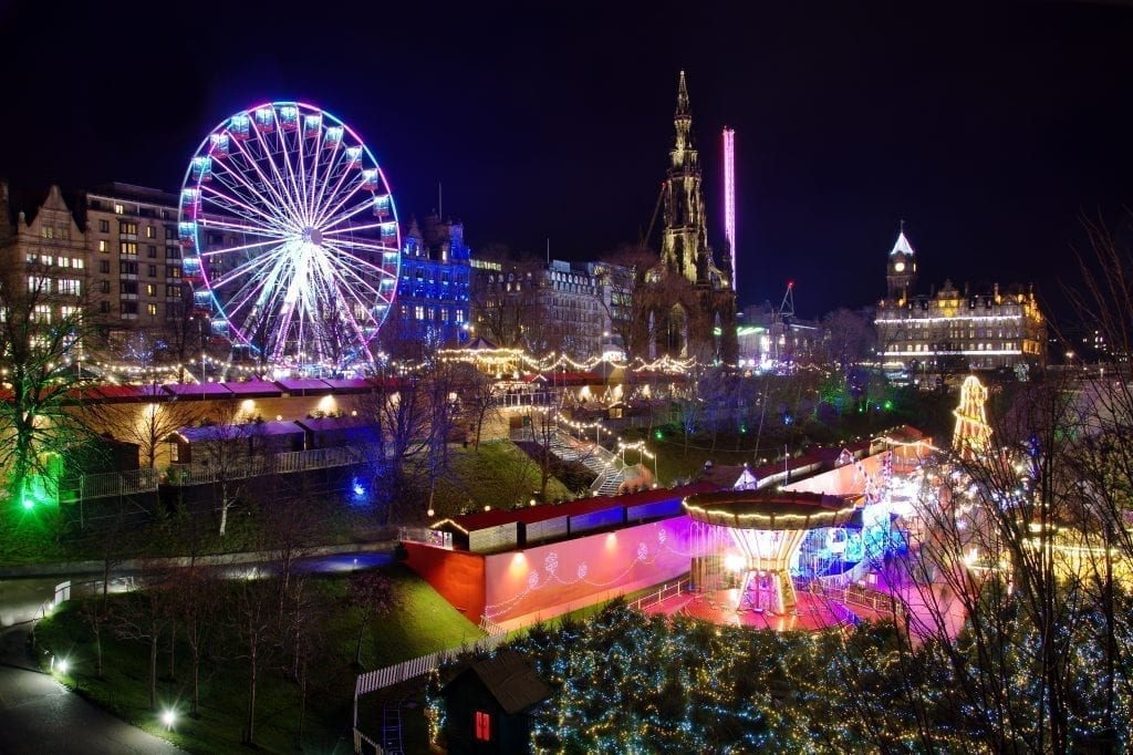 Prince Street Winter Market in Edinburgh Scotland at night with a Ferris wheel on the left side of the photo