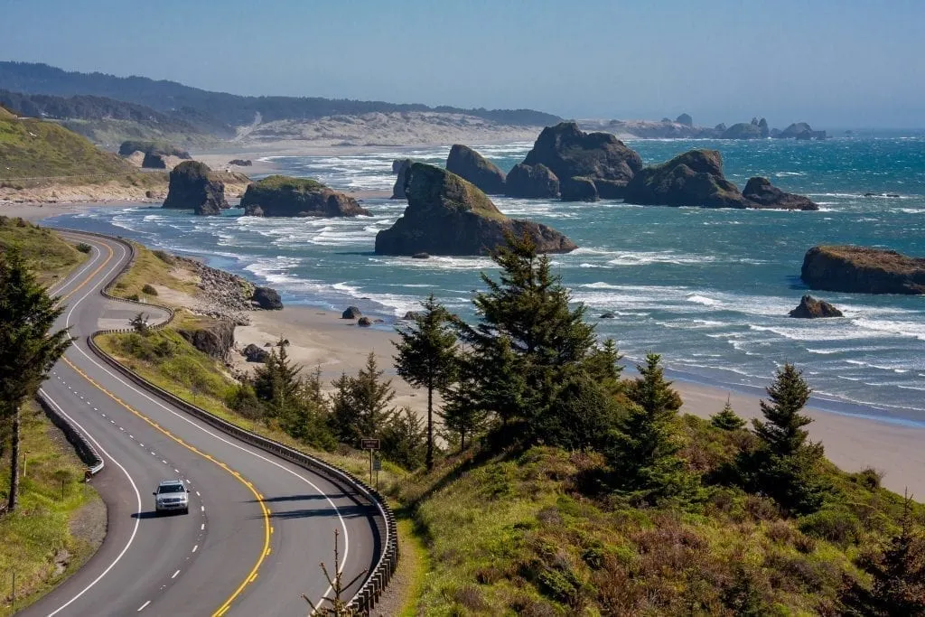 One car driving along the oregon coast as shot from above