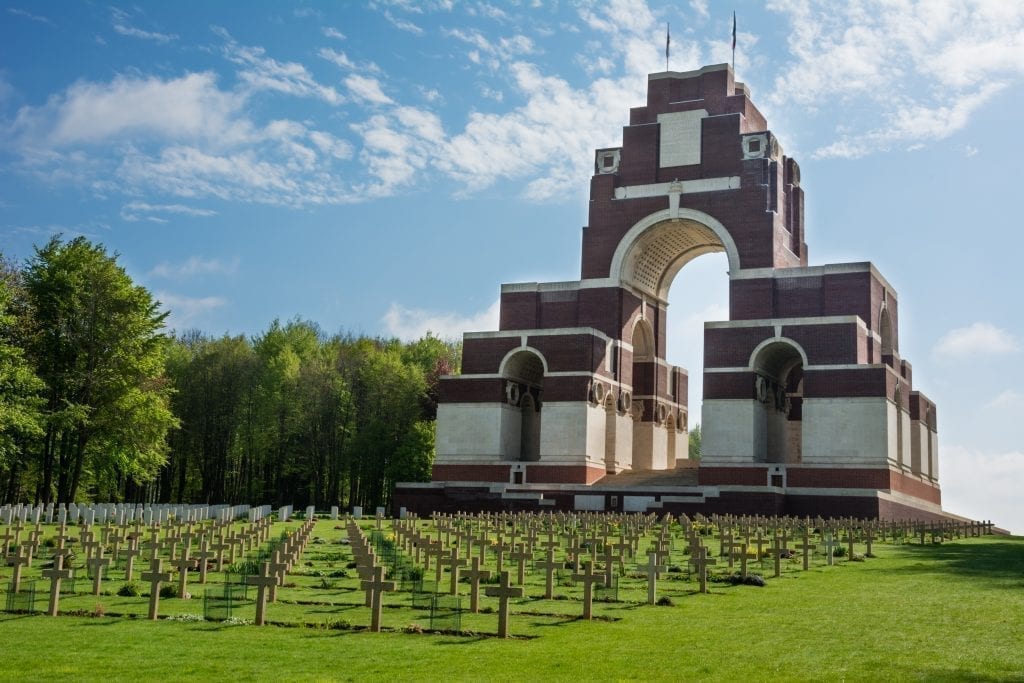 WWI Battlefield memorial with a large structure in the background and crosses in the foreground