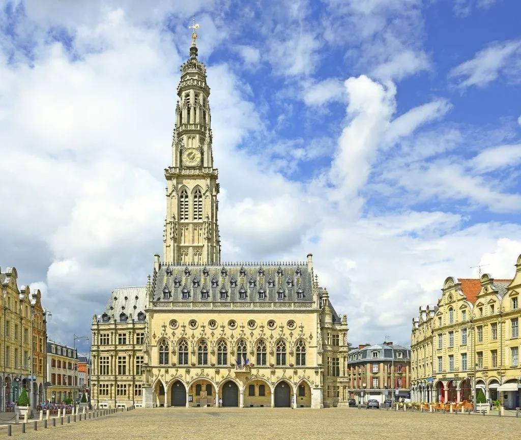 Arras France town hall as seen across an empty square. Arras is one of the best day tours from Paris France