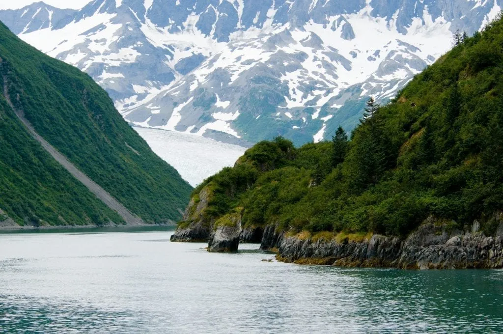 fjord in alaska with a glacier visible in the background of the image. alaska is an incredible place for west coast usa road trip ideas